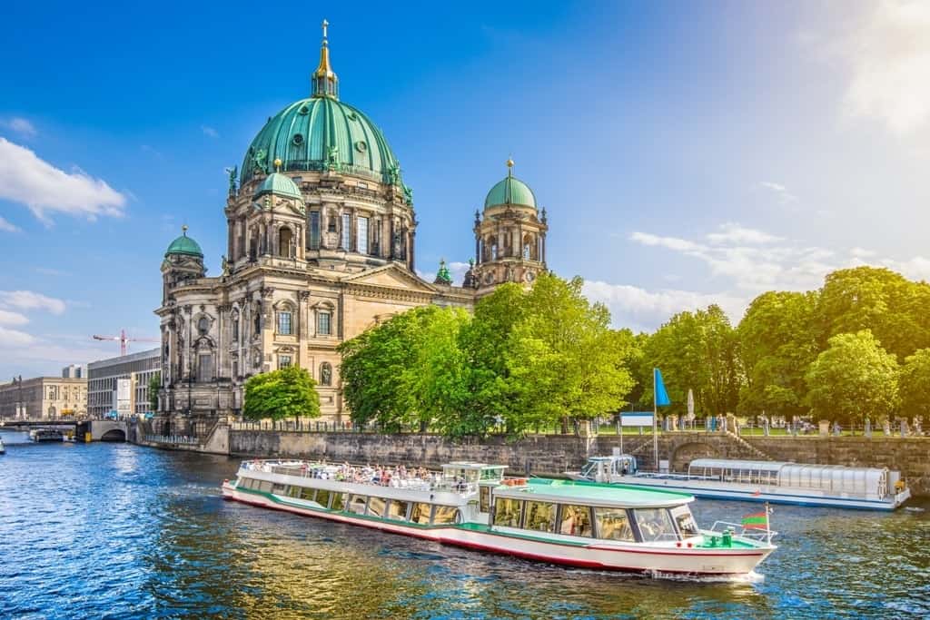 Beautiful-view-of-Berliner-Dom-Berlin-Cathedral-at-famous-Museumsinsel-Museum-Island-with-excursion-boat-on-Spree-river-in-beautiful-evening-light-at-sunset-Berlin-Germany-min.jpg